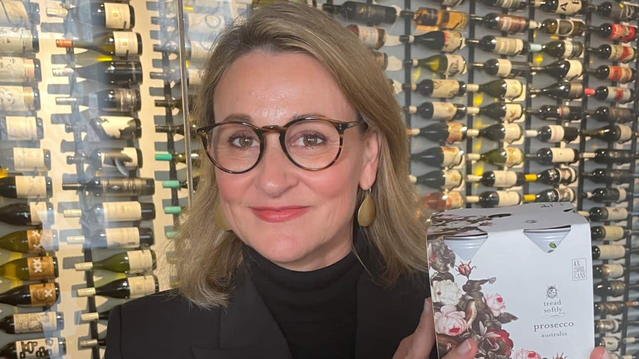 Rowena Curlewis, co-founder of Denomination, holding a pack of wine cans.