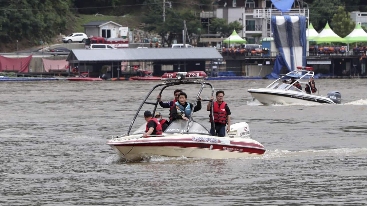 Rescue workers on rubber boats search for missing persons on floodwaters in Gapyoeng, South Korea.