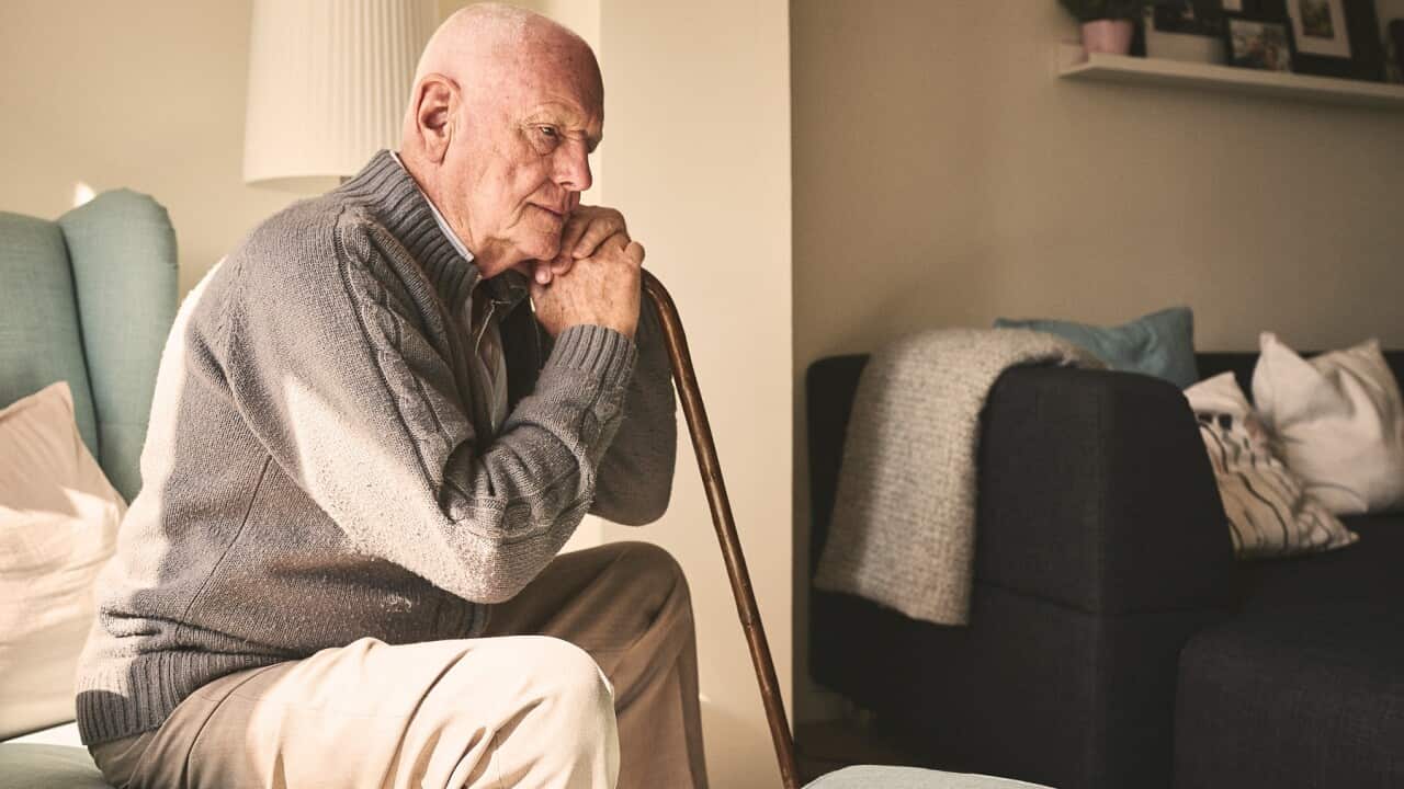 Elderly man sitting alone at home