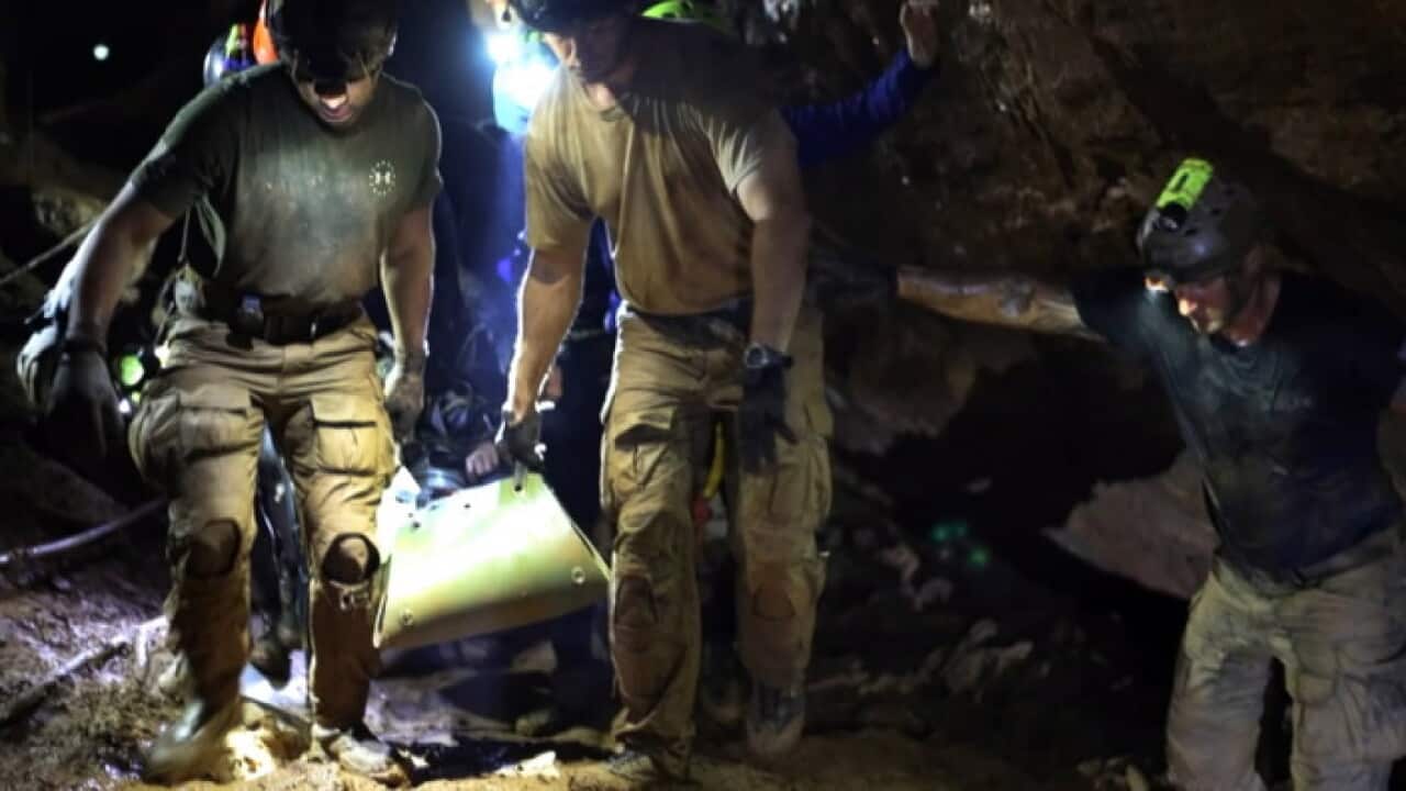 Rescuers carry a boy out of the Thai cave on a stretcher