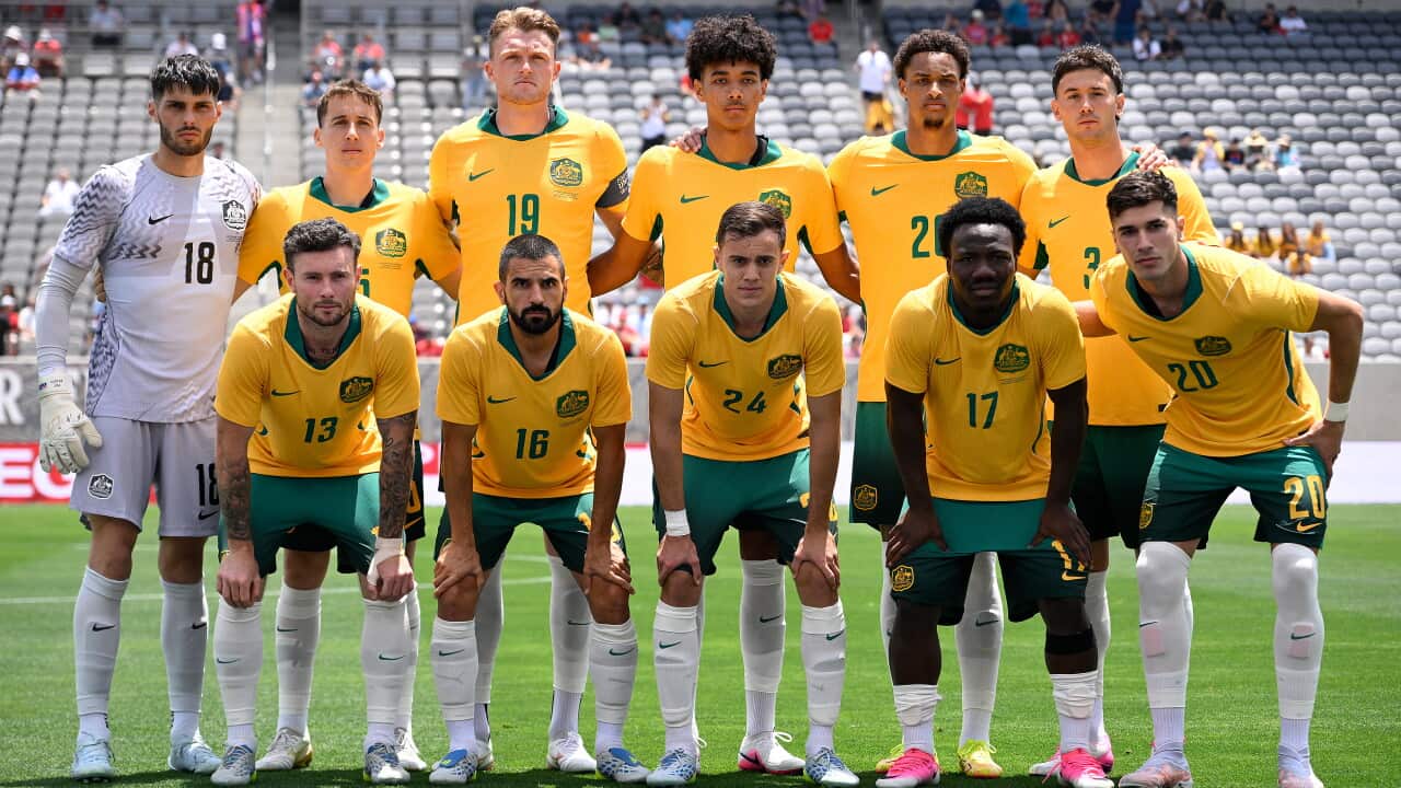 A football team wearing green and gold.