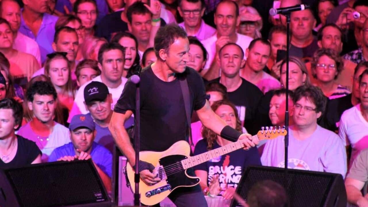 Mitchell Roth (pictured here with glasses to the right of Springsteen) says attending the shows make him feel at home.