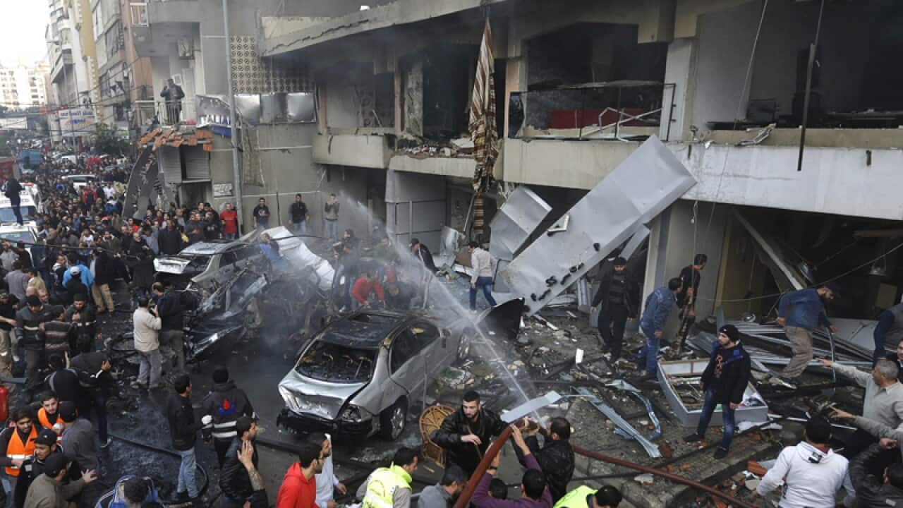 A crowd outside a bombing site in a stronghold of the Hezbollah group
