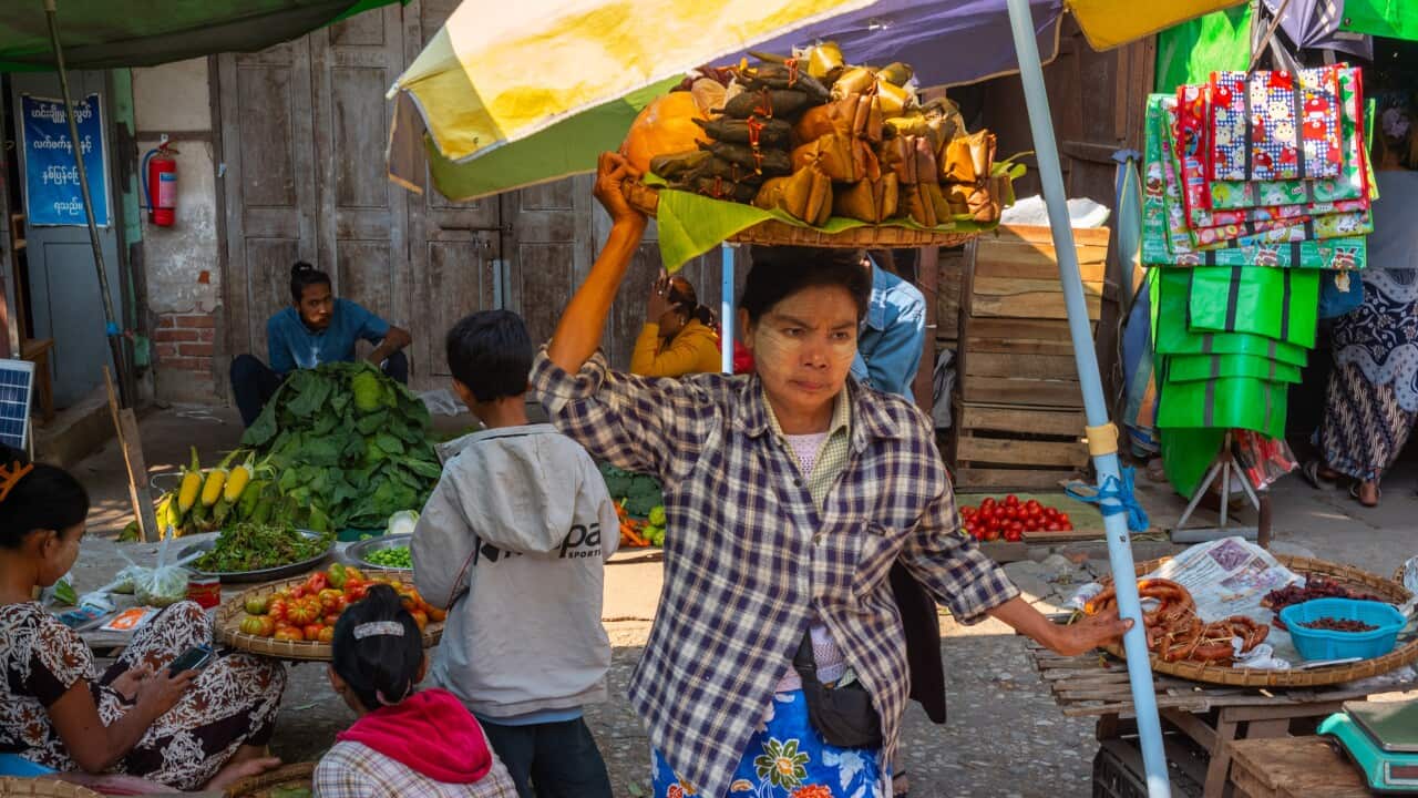 A woman carries a tray of food