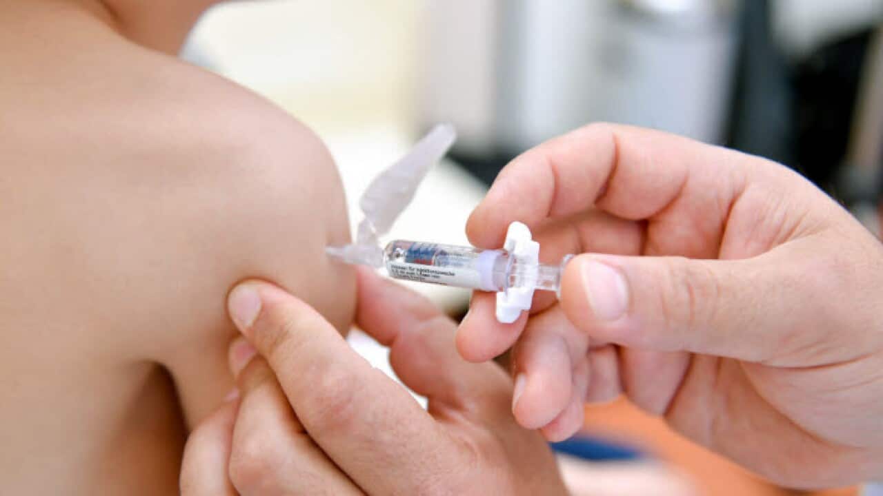 A pediatrician shows a measles vaccine
