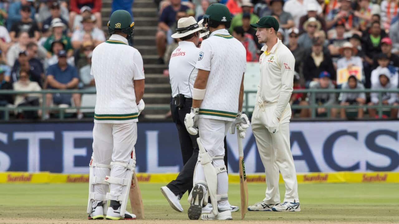Cameron Bancroft (right) is questioned by umpires regarding ball tampering in the third cricket test between South Africa and Australia