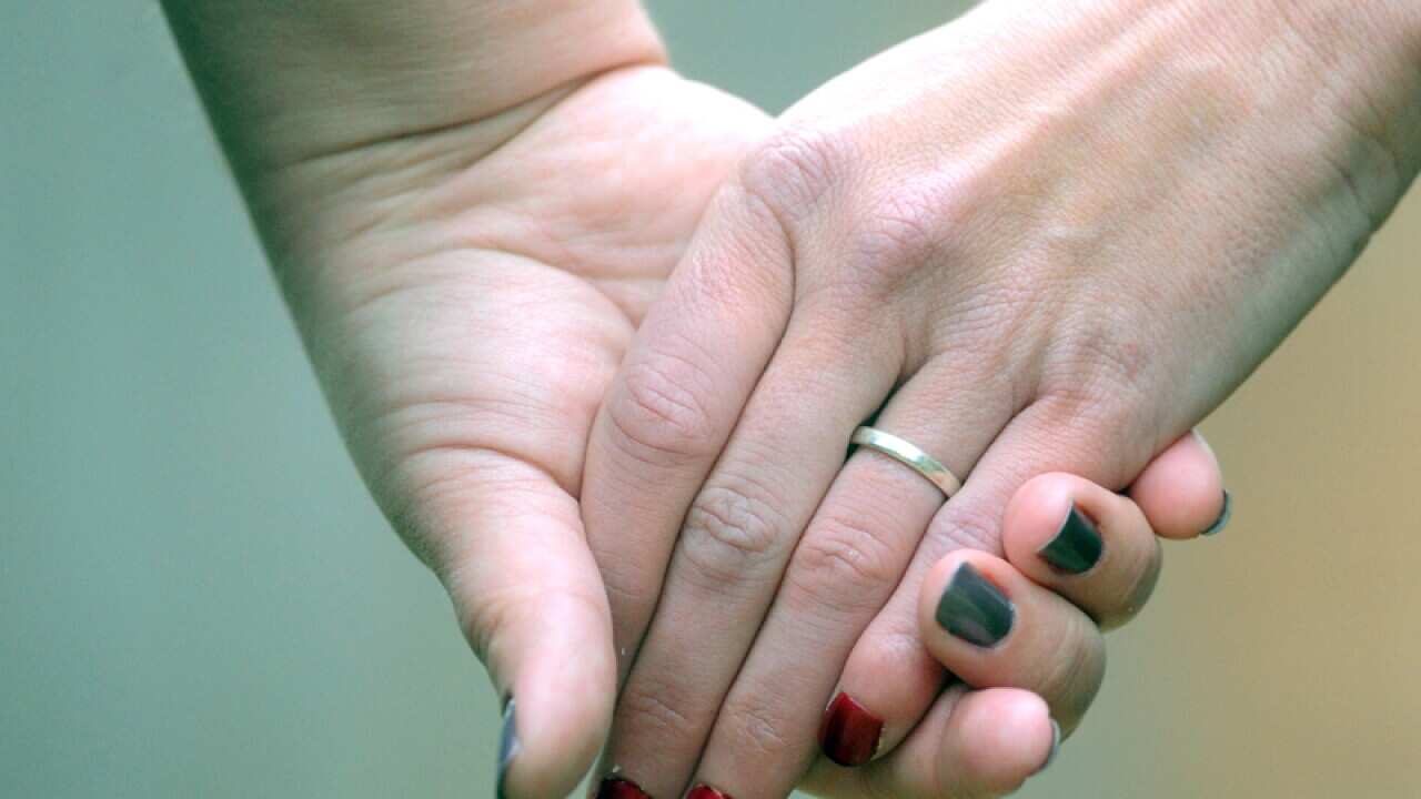 File photo of two women holding hands