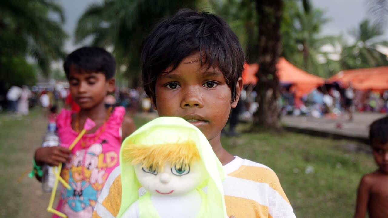A Rohingya migrant girl holds a doll at a temporary shelter in Bayeun village, Aceh province, Indonesia. (EPA)