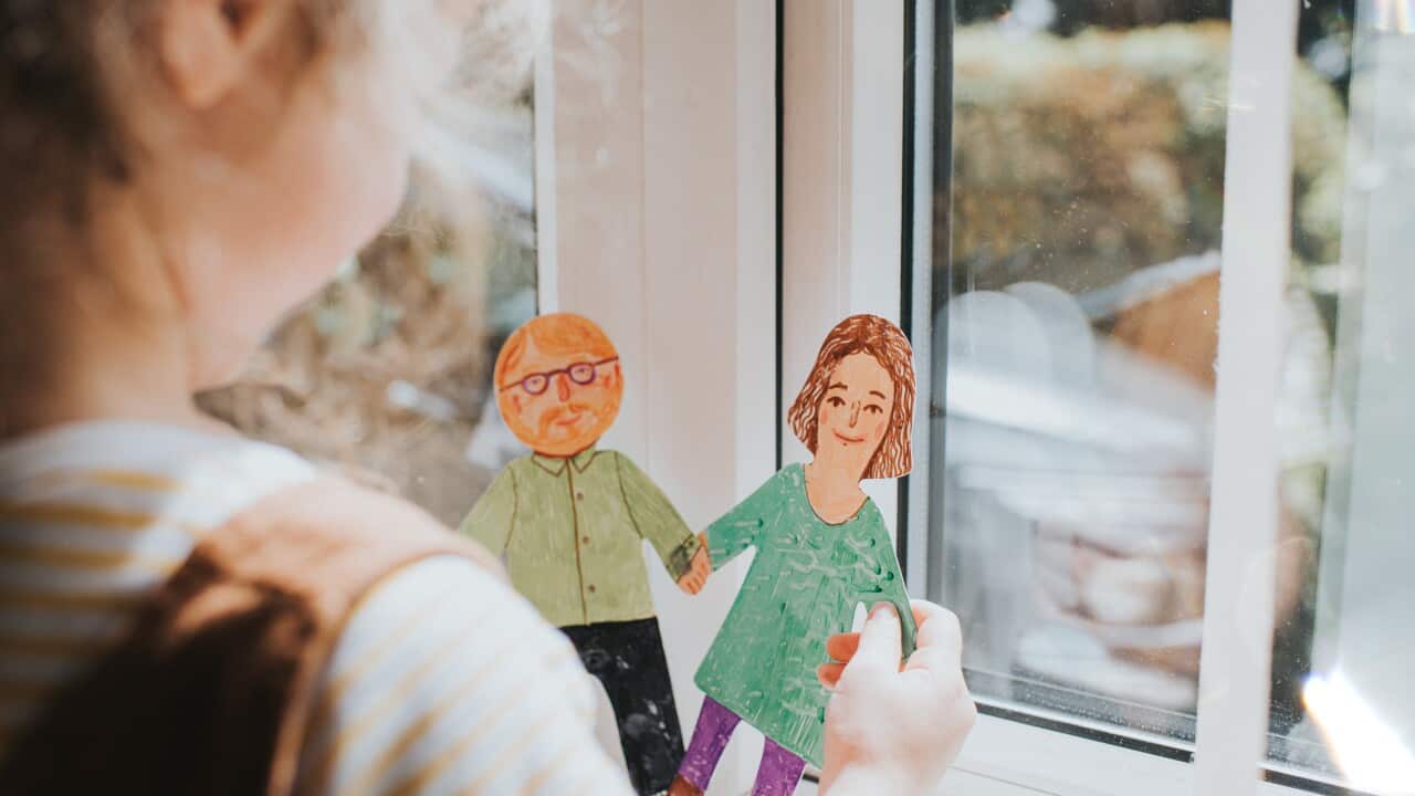 Little girl holding cut-out paper People