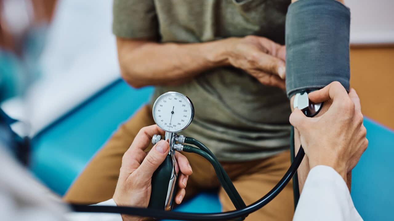 Close up of doctor measuring blood pressure of an elderly patient.