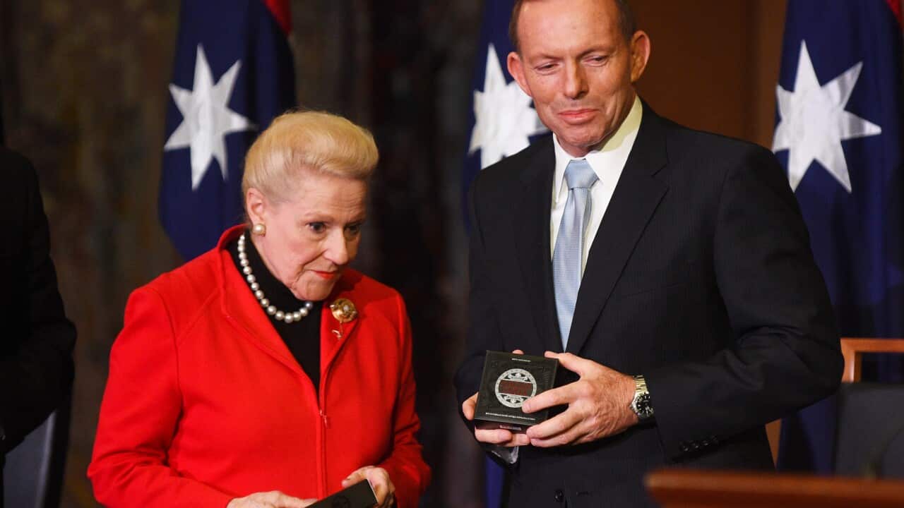 Federal Speaker of the House Bronwyn Bishop and Prime Minister Tony Abbott receive commemorative coins at the Magna Carta 800th anniversary celebration at Parliament House in Canberra, Monday, June 15, 2015. (AAP Image/Mick Tsikas) NO ARCHIVING