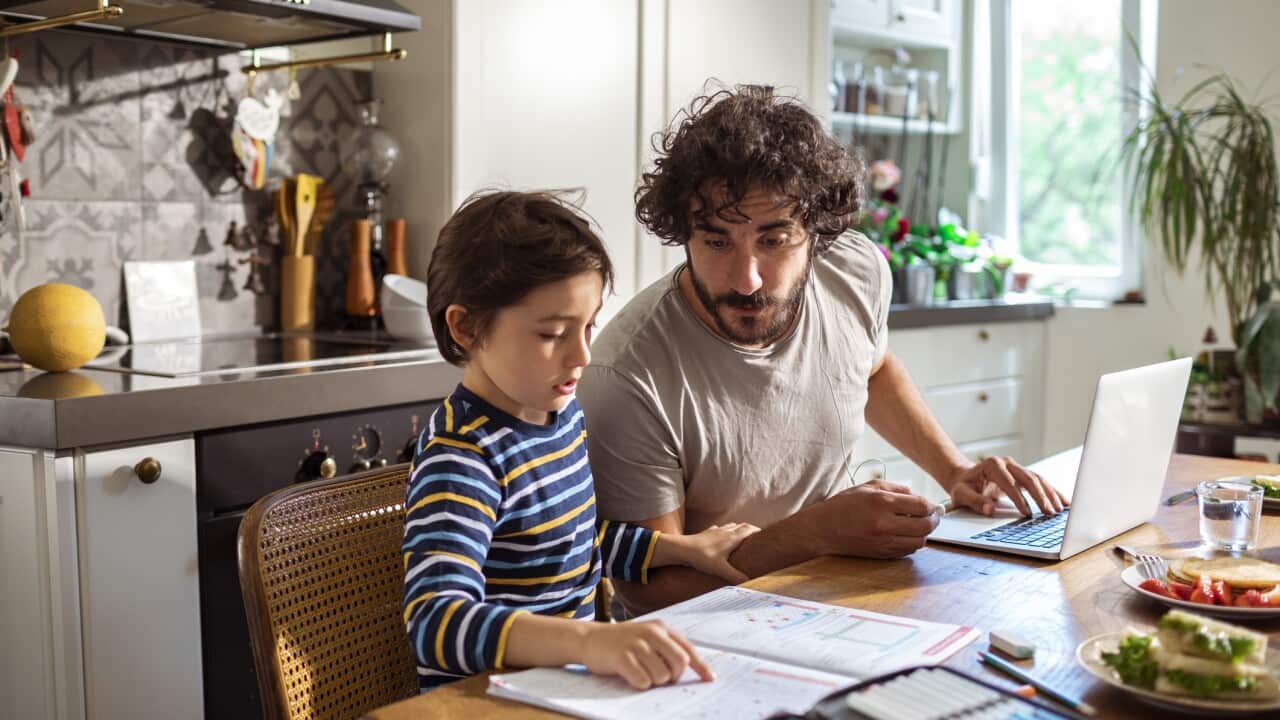 Father helping his son with schoolwork