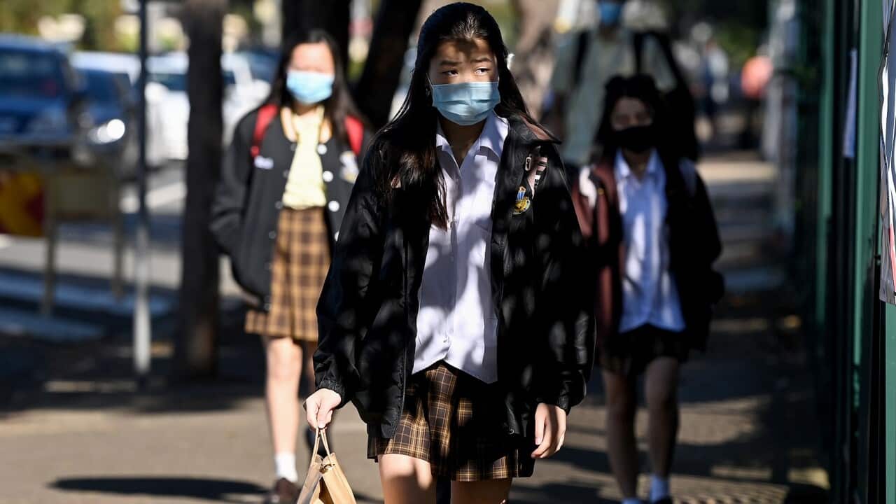 Students wear face masks as they return to school at Fairvale High School in Sydney