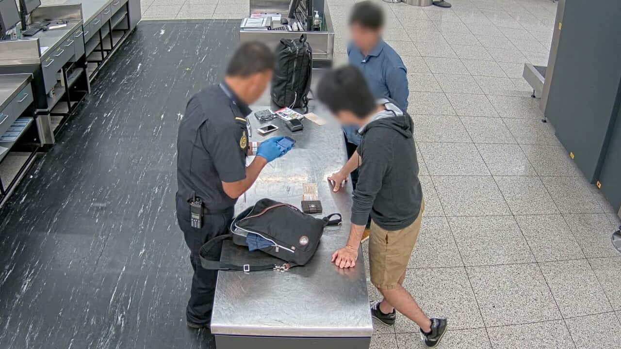 The Japanese tourist arrested at Perth Airport last November (in the foreground wearing brown shorts)