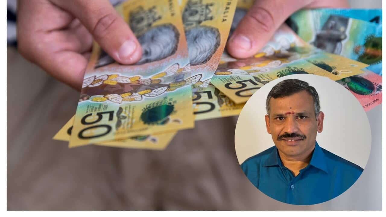 Male person holding some Australian currency