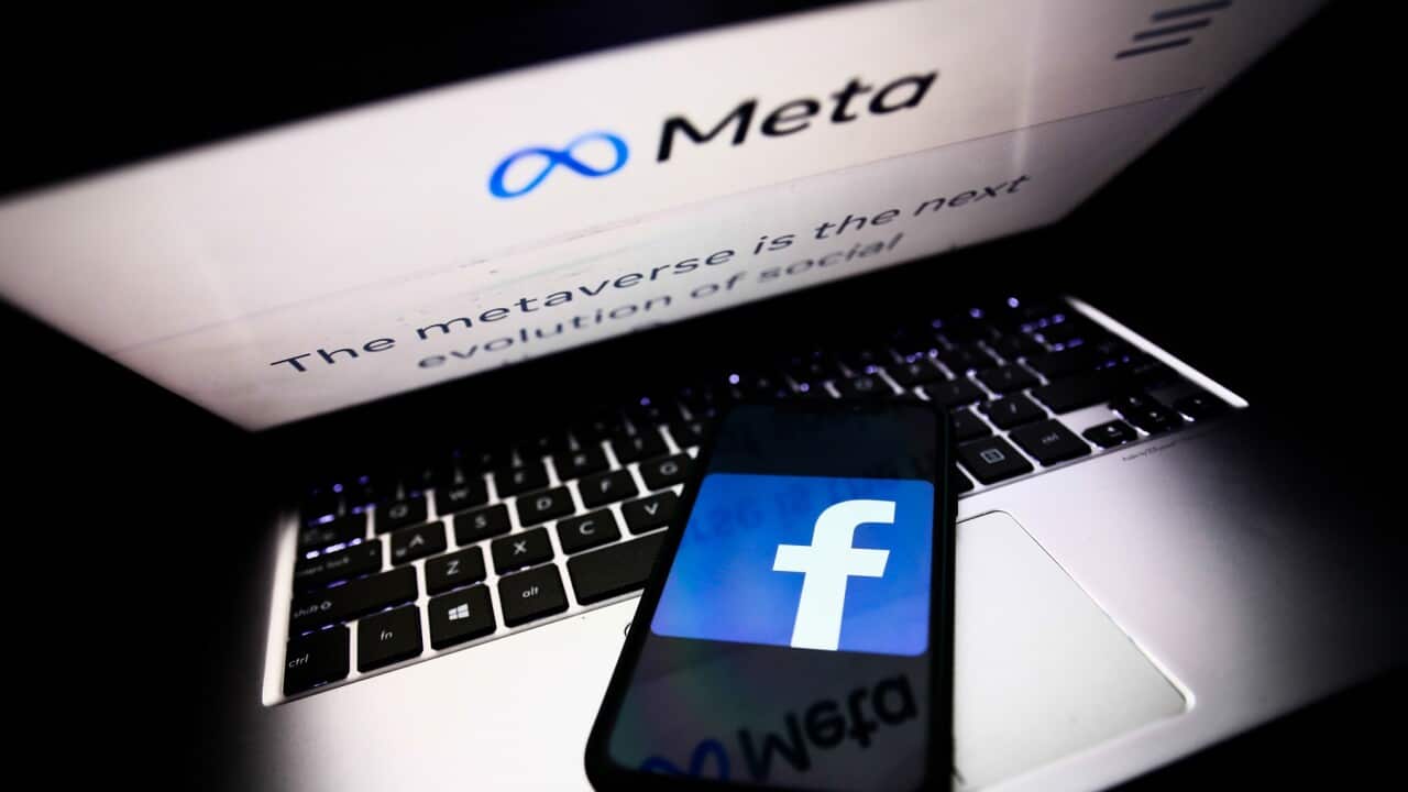Meta website on a laptop screen and Facebook app logo on a phone screen