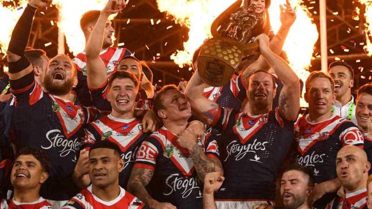 The Roosters celebrate their win over the Storm during the 2018 NRL Grand Final between the Sydney Roosters and the Melbourne Storm at ANZ Stadium in Sydney, Sunday, September 30, 2018.