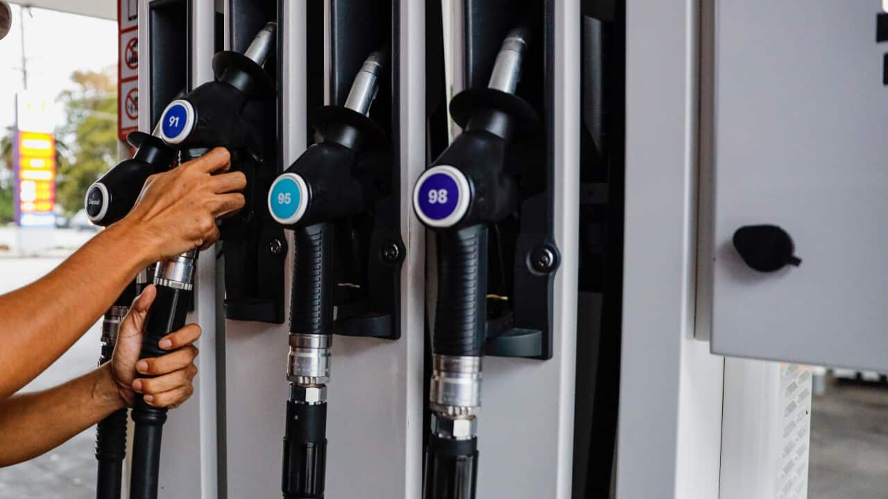 A car's petrol tank and a petrol price board