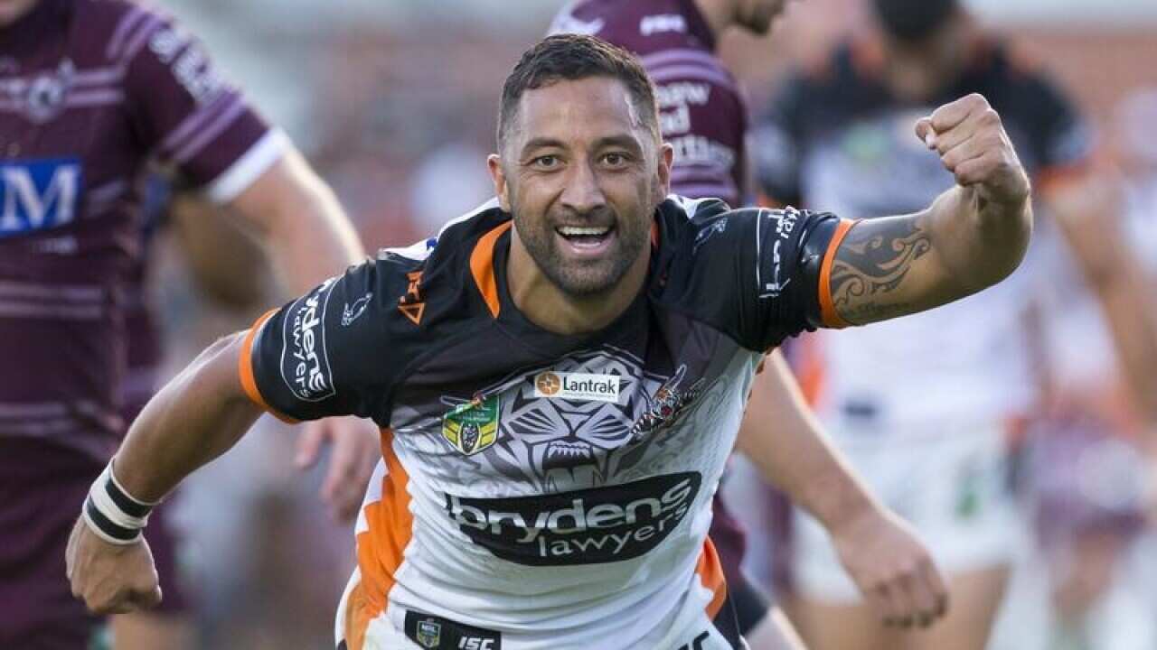 Benji Marshall of the Tigers celebrates after scoring.