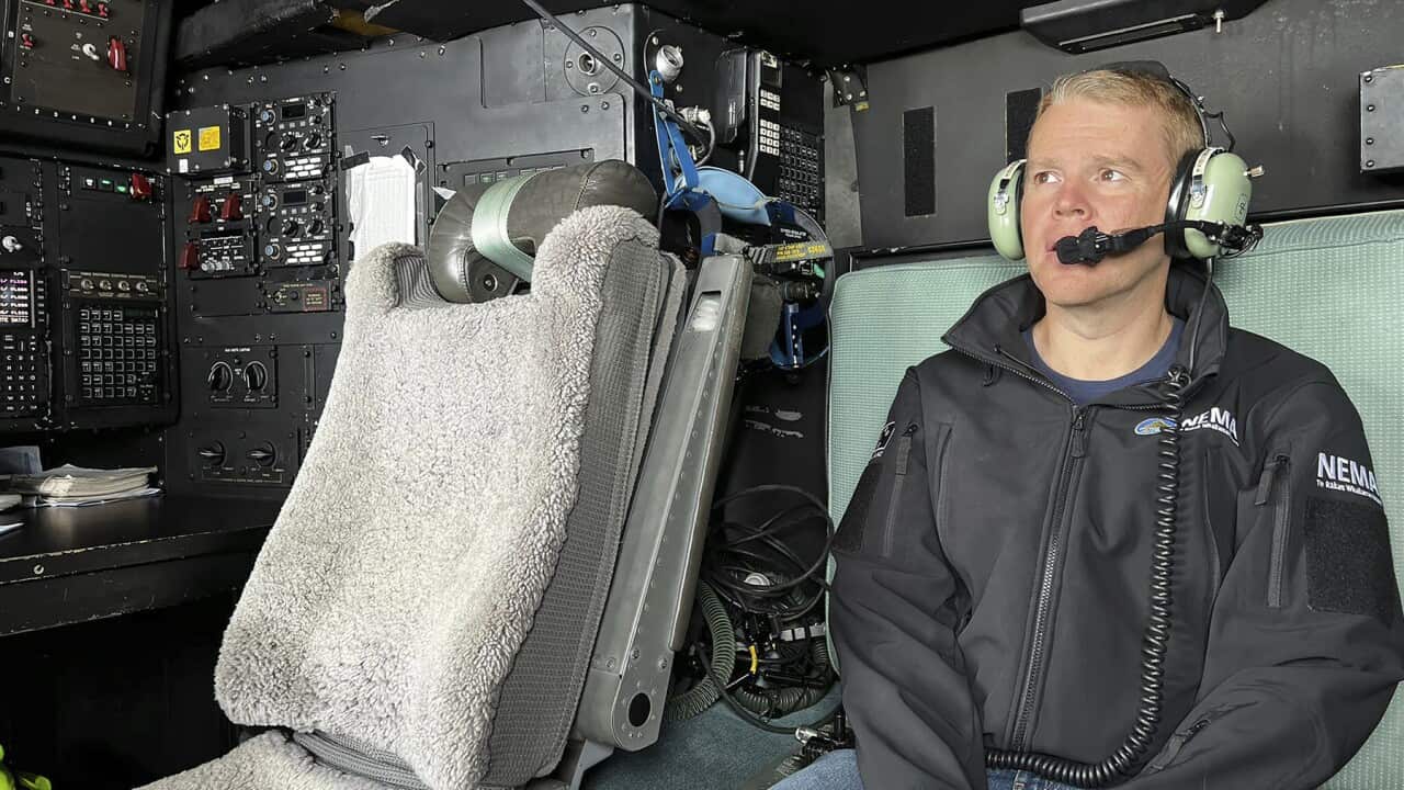 New Zealand's Prime Minister Chris Hipkins surveys the flood damage