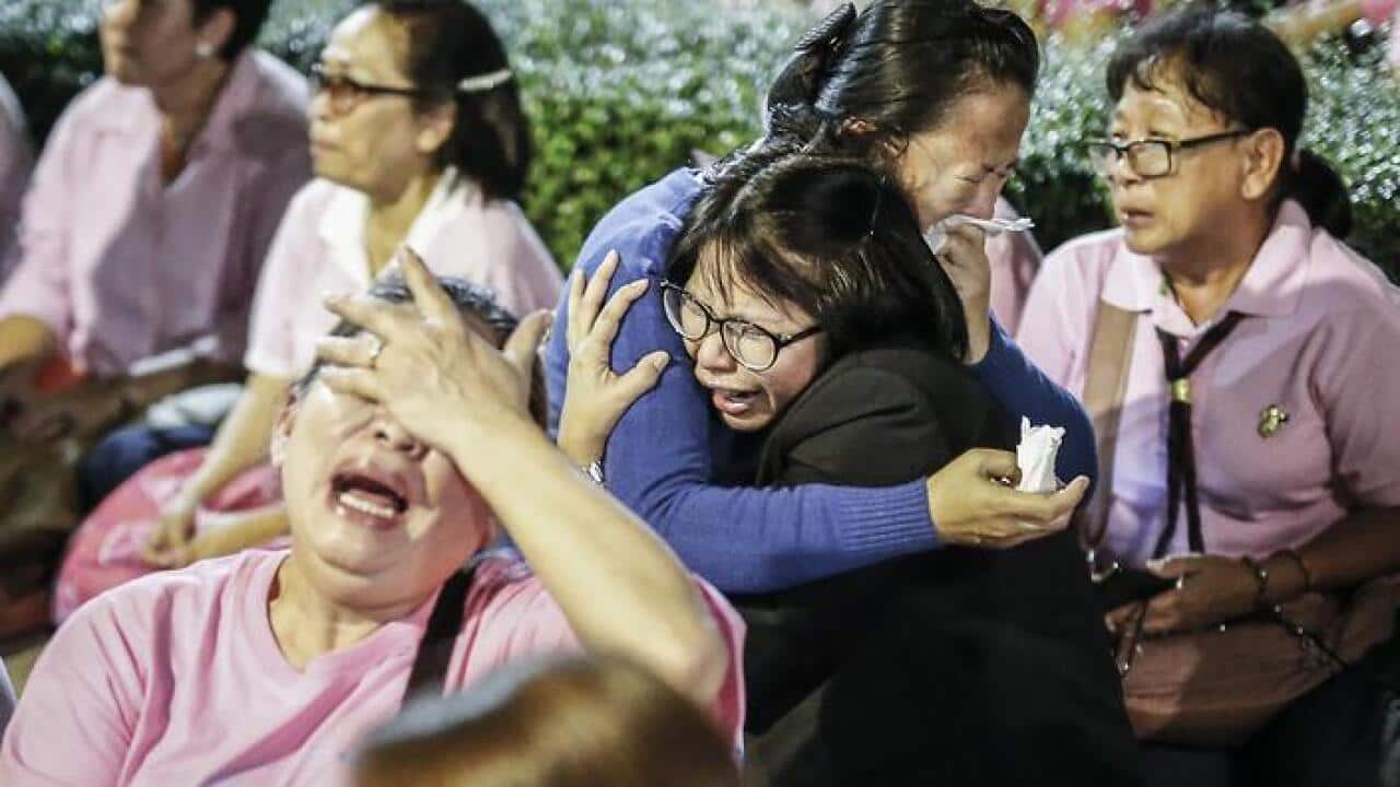 Thai well-wishers mourn King Bhumibol Adulyadej after the announcement of his death at the Siriraj Hospital in Bangkok, Thailand (AAP)