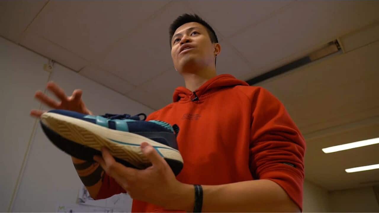Jesse Tran with one of his sneakers made from coffee grounds