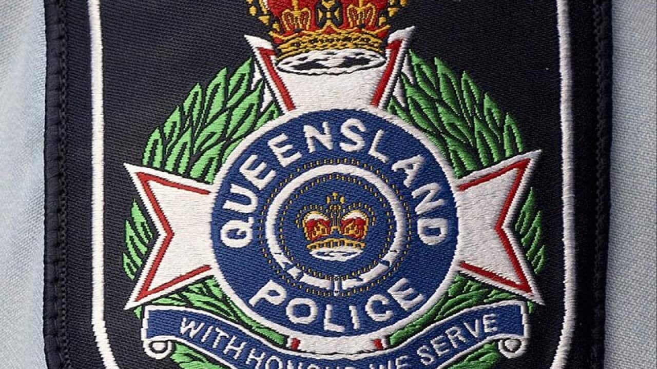 Stock photograph of a badge on the arm of a Queensland police officer