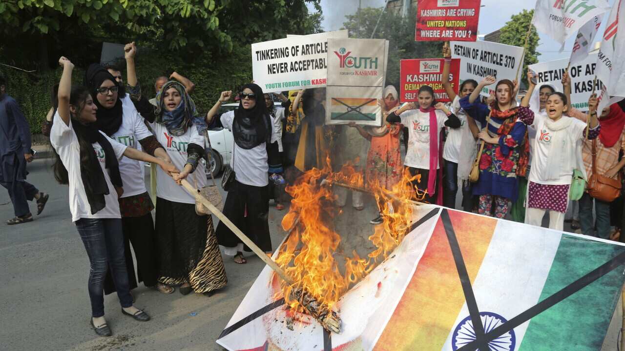 Pakistani students burn a poster of Indian Premier Narendra Modi during an anti-Indian rally in Lahore, Pakistan.