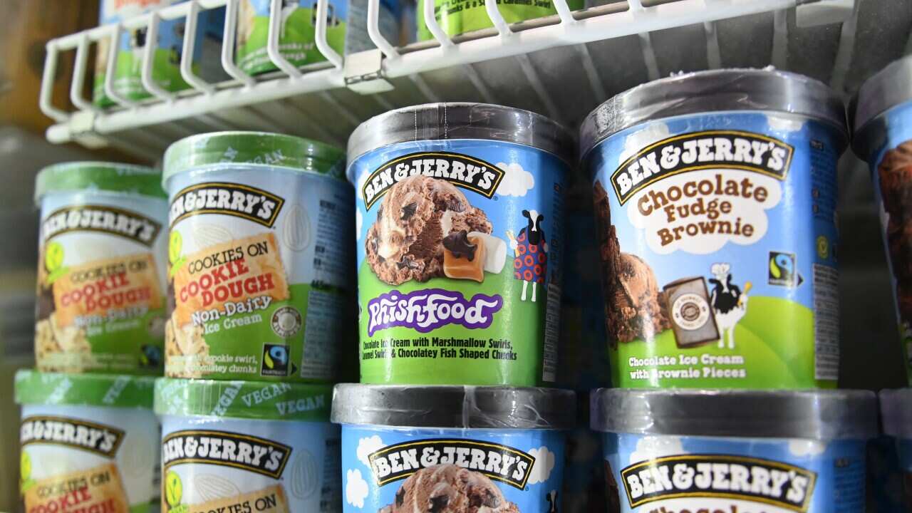 Tubs of Ben & Jerrys ice cream on a freezer shelf.