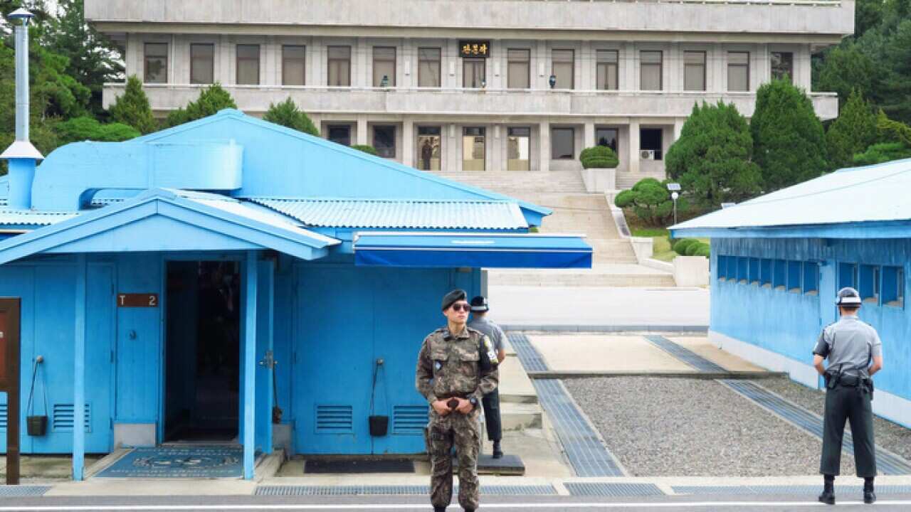 South Korean soldiers stand guard in front of North Korea's main building in a joint security area at the border village of Panmunjeom