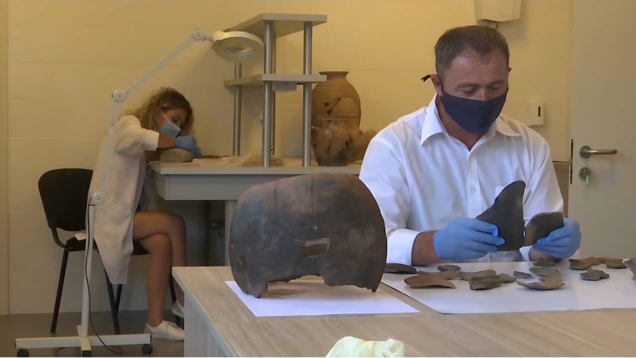 Researchers examining items from an excavated Neolithic site (AP).jpg