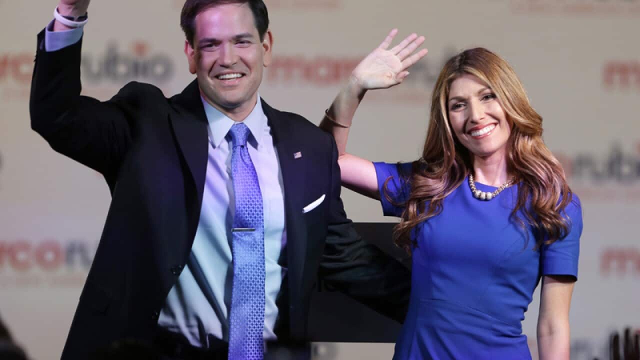 Marco Rubio waves to supporters with his wife Jeanette in Miami