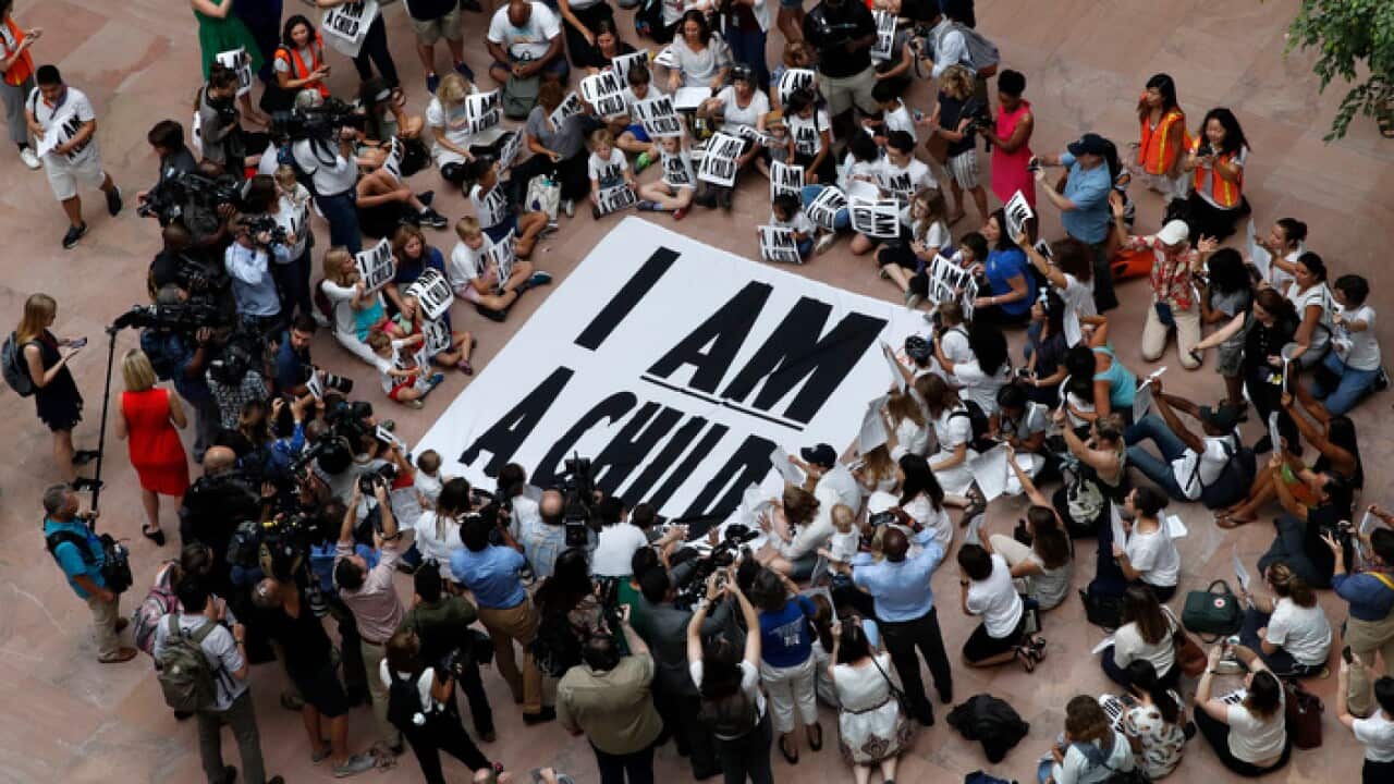 Families with young children protest the separation of immigrant families with a sit-in at the Hart Senate Office Building.