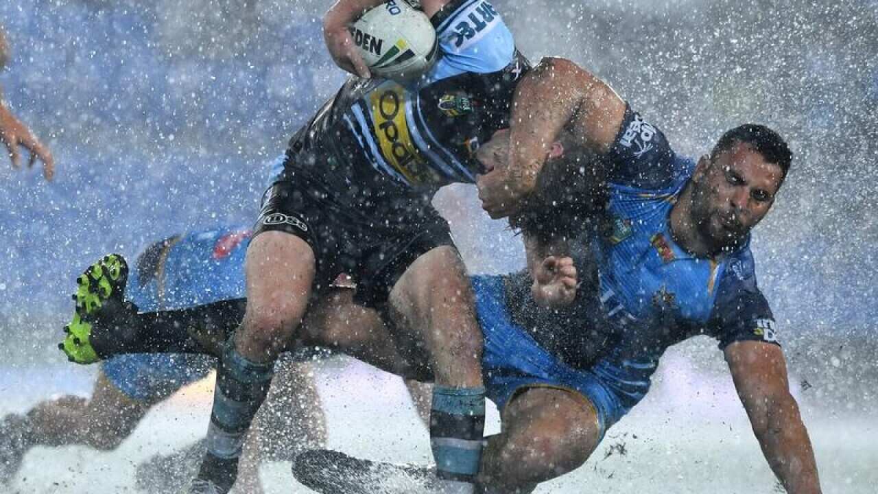 Chad Townsend is tackled by Titans player Ryan James