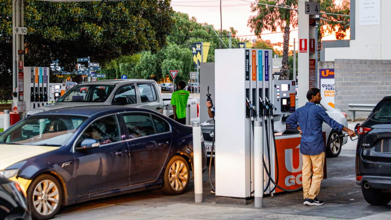 People queue to fuel their vehicles