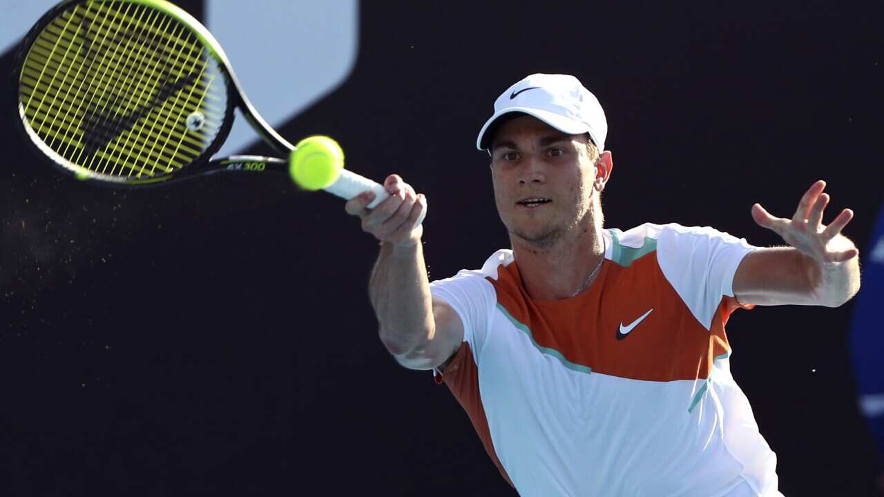 Miomir Kecmanovic of Serbia plays a forehand return to Salvatore Caruso of Italy during their first round match at the Australian Open tennis championships in Melbourne, Australia, Monday, Jan. 17, 2022. (AP Photo/Tertius Pickard)