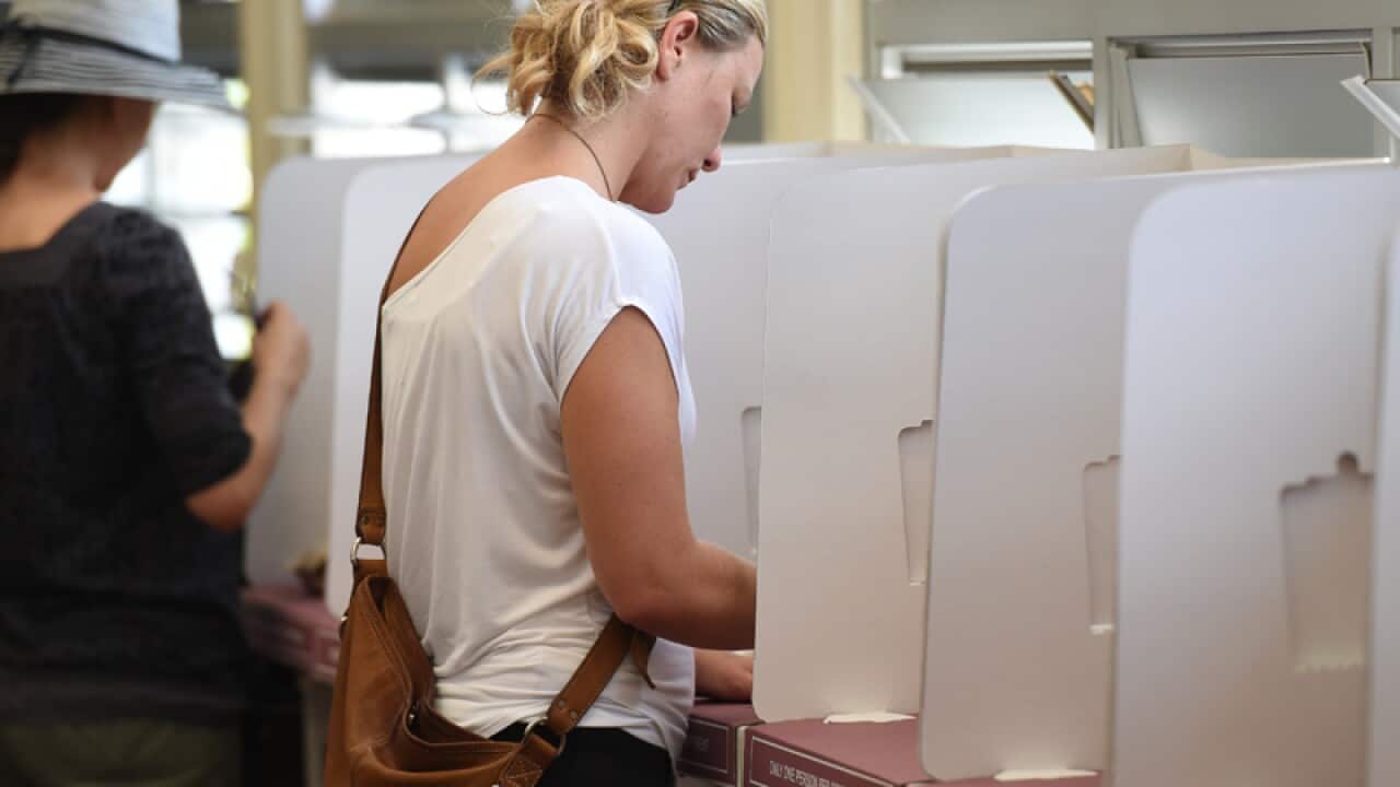 A voter casts her ballot
