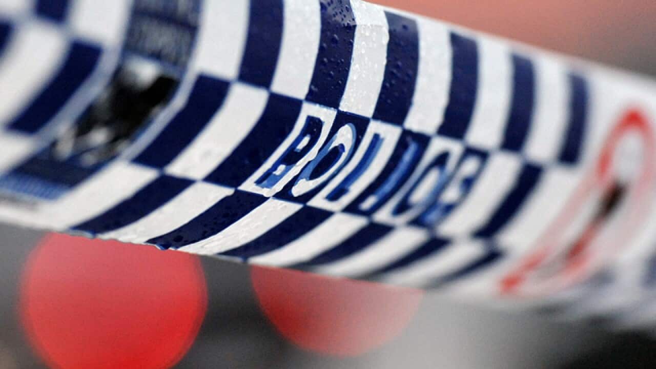 Police tape restricts access to a crime scene