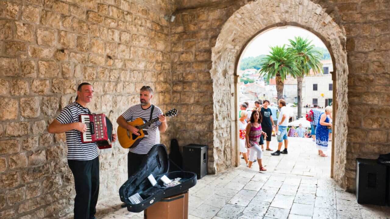 Busking at the entrance to Korcula Town, Korcula Island, Croatia.