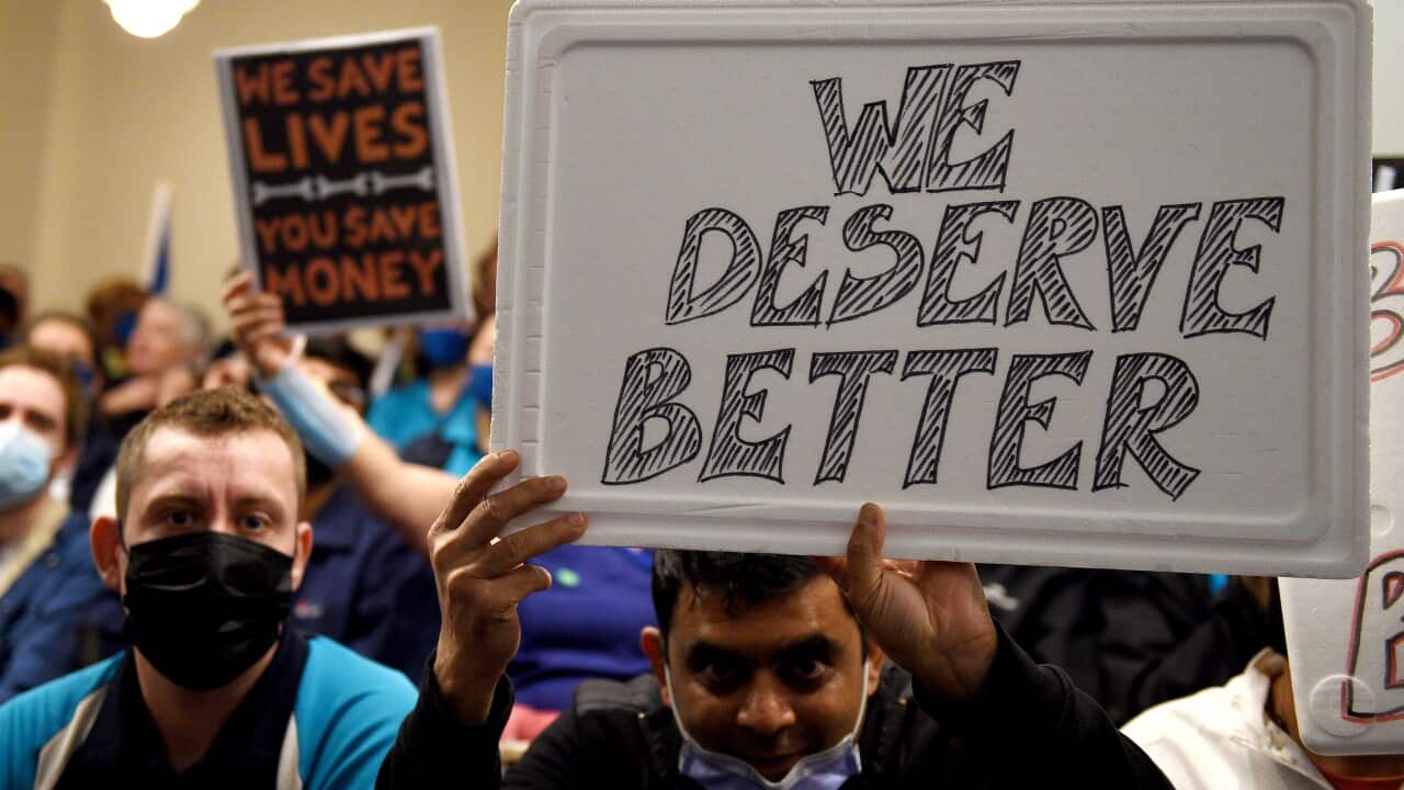 NSW heath workers hold placards during a strike by NSW Health workers in Sydney.