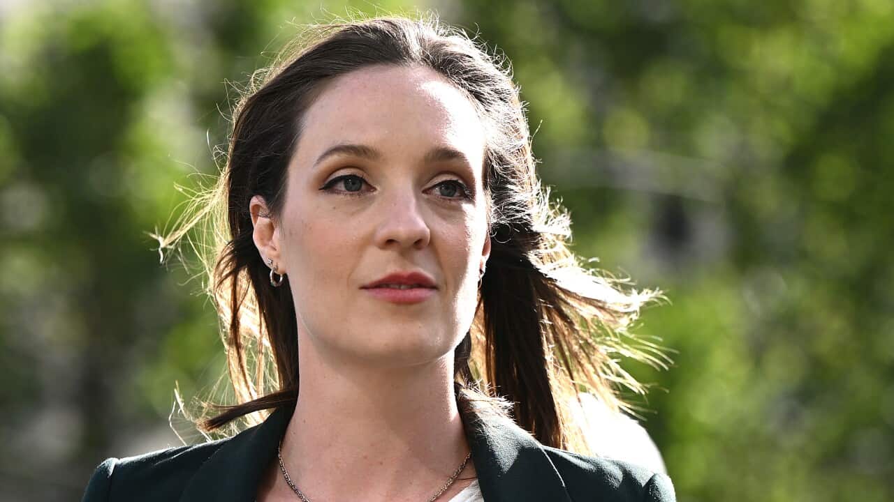 A woman arrives at a court.