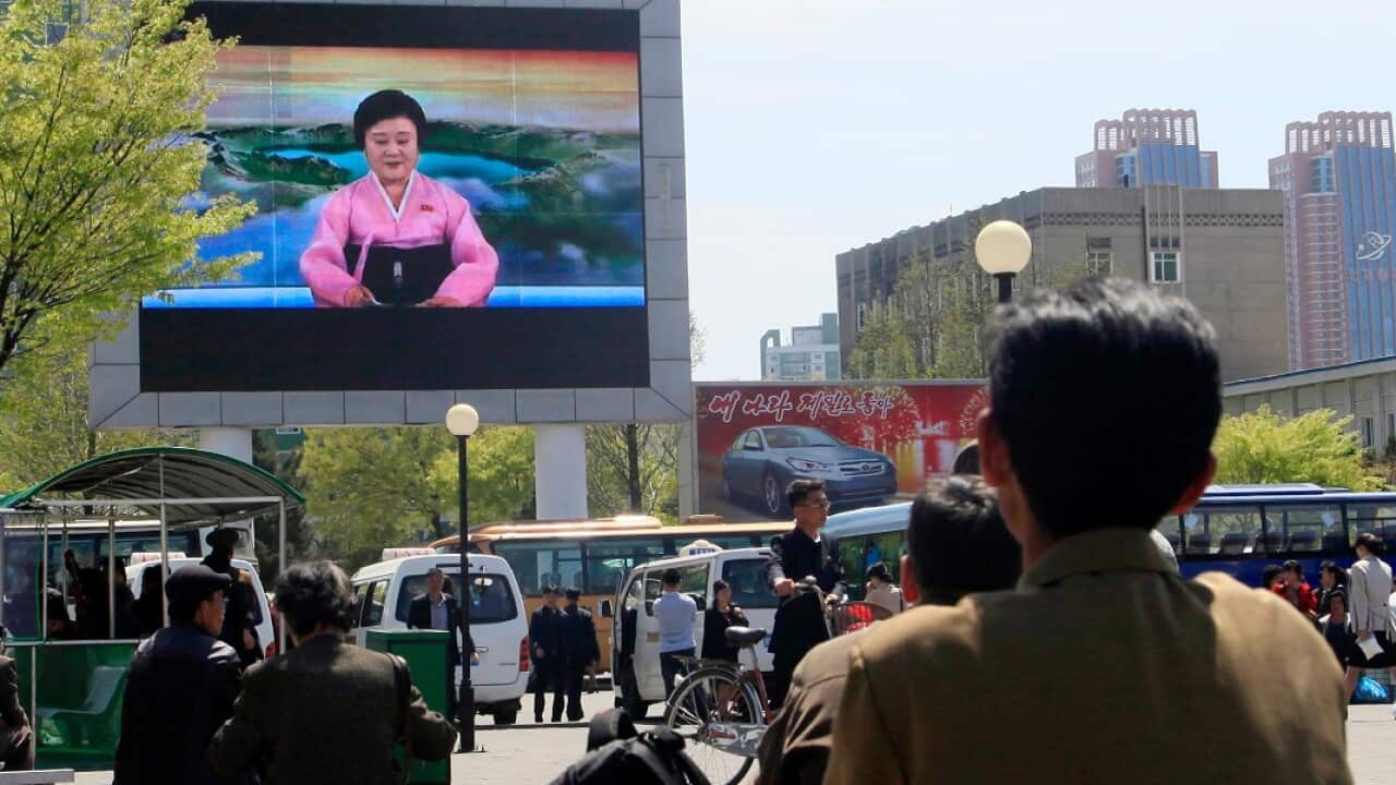 North Koreans watch as their country's most famous newscaster announces leader Kim Jong-un's proposal to suspend nuclear tests.