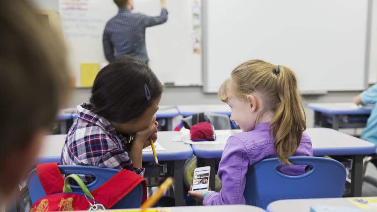 Students using phone in the classroom