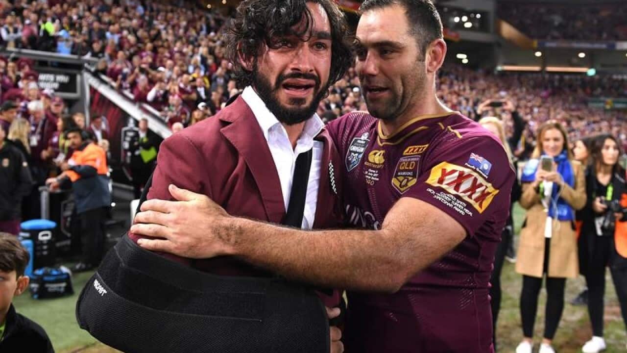 Cameron Smith of Queensland reacts with Johnathan Thurston.