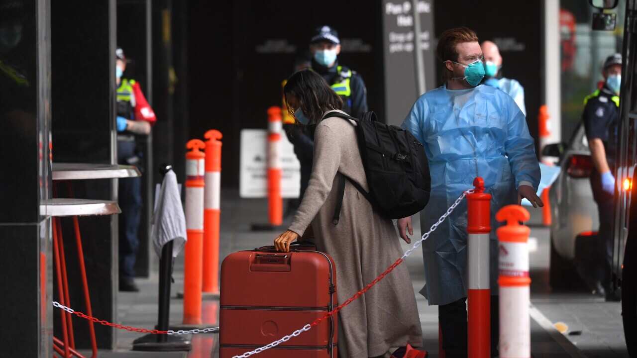 Passengers are seen disembarking a SkyBus and entering a hotel quarantine facility in Melbourne, Monday, December 7, 2020