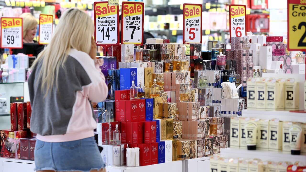 A woman walking inside a shop