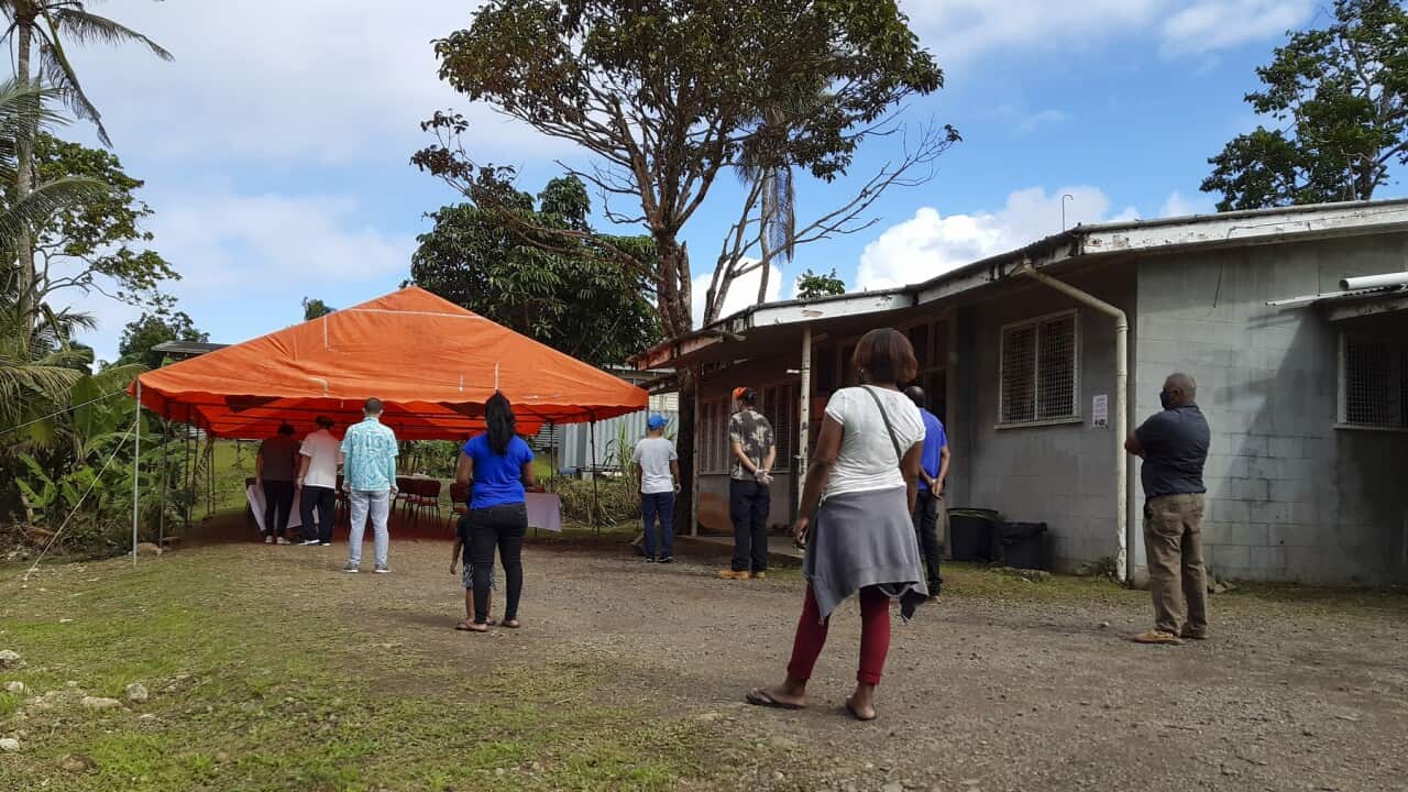 People queue for a COVID-19 vaccination in Suva, Fiji