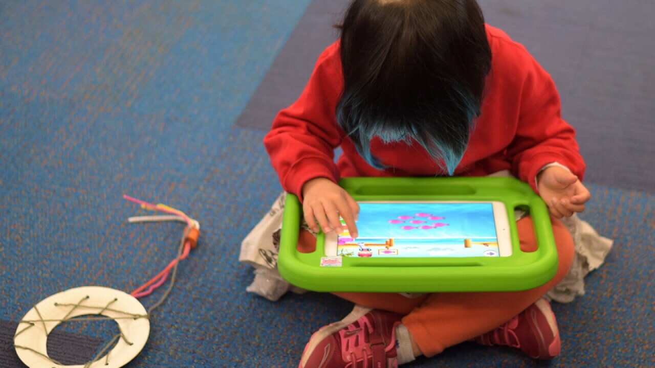 A child plays on an iPad