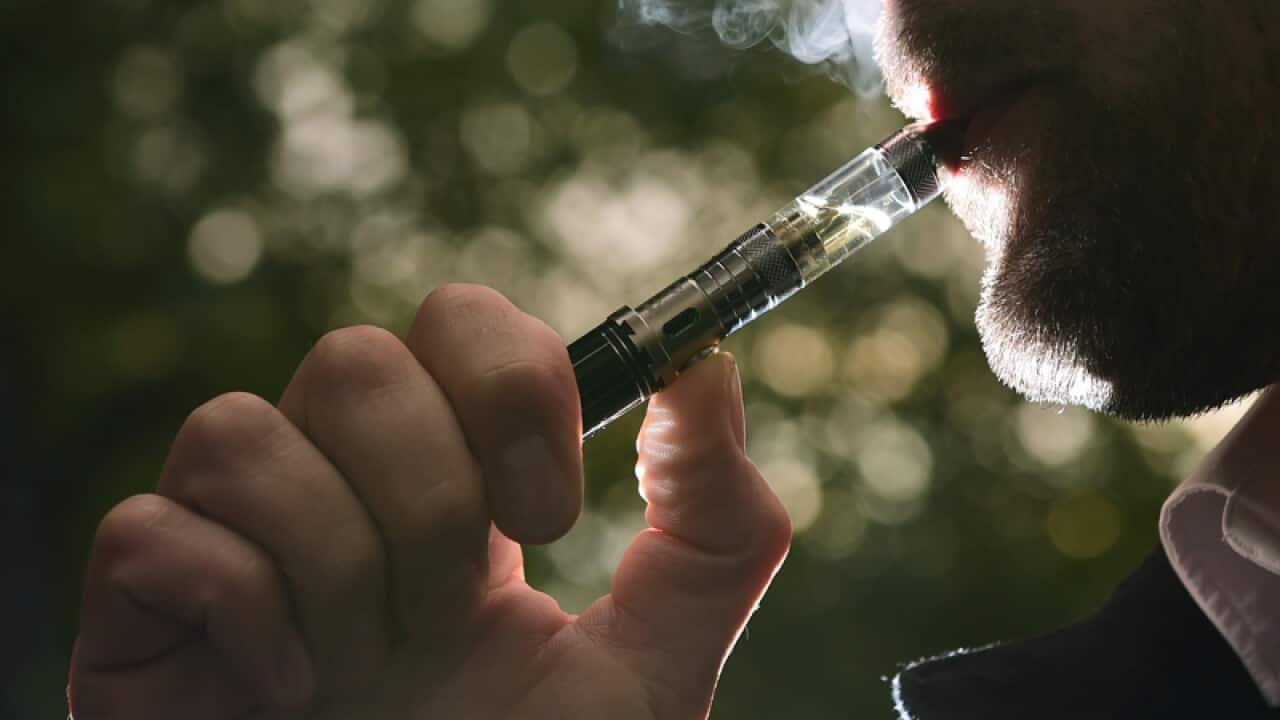 A man smokes an e-cigarette