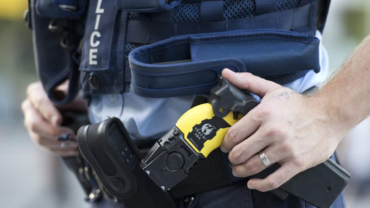 A police officer with a Taser stun gun